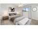 Bright bedroom with a ceiling fan, plush carpet, and a comfortable bed with stylish decor and a street view from the window at 2261 E Decatur St, Mesa, AZ 85213