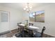 Bright dining area features wood floors and a stylish chandelier at 2261 E Decatur St, Mesa, AZ 85213