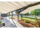 Charming covered outdoor patio with brick planters, perfect for relaxing and enjoying the landscaped yard at 2261 E Decatur St, Mesa, AZ 85213