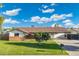 Charming single-story home features a well-manicured lawn, a large driveway, and a cozy front porch at 2261 E Decatur St, Mesa, AZ 85213
