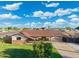 Wide angle shot of cozy home with a well-maintained front yard, covered carport, and brick accents at 2261 E Decatur St, Mesa, AZ 85213