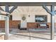Inviting front porch with brick accents, decorative wreath, welcome mat, and cozy bench at 2261 E Decatur St, Mesa, AZ 85213
