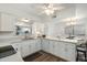 Bright kitchen with white cabinetry, modern countertops, and stainless steel appliances open to eating area at 2261 E Decatur St, Mesa, AZ 85213