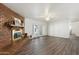 Spacious living room with hard wood floors, ceiling fan, brick fireplace, and french doors at 2261 E Decatur St, Mesa, AZ 85213