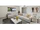 Bright living room featuring a comfortable sofa, accent pillows, and a large window overlooking the street, for a relaxing space at 2261 E Decatur St, Mesa, AZ 85213