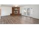 Open living room featuring wood floors, a ceiling fan, and a fireplace with brick surround at 2261 E Decatur St, Mesa, AZ 85213