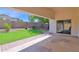 Covered patio area with mature trees and a beautiful yard at 2620 E Rustling Oaks Ln, Phoenix, AZ 85024