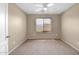 Neutral bedroom features a ceiling fan and window to provide natural light at 2620 E Rustling Oaks Ln, Phoenix, AZ 85024