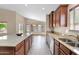 Open kitchen with granite countertops, stainless steel sink, and view to the dining area at 2620 E Rustling Oaks Ln, Phoenix, AZ 85024