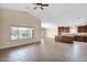 Bright open living space featuring tile floors, high ceilings, dark cabinets, and plenty of natural light at 2620 E Rustling Oaks Ln, Phoenix, AZ 85024