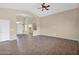 Open-concept living area with tile floors, neutral walls, a ceiling fan, and a view of the front entry at 2620 E Rustling Oaks Ln, Phoenix, AZ 85024