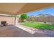Covered patio area with green grass and brick trim at 2620 E Rustling Oaks Ln, Phoenix, AZ 85024