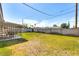 A spacious backyard offers ample green space and a covered patio with seating area, ideal for relaxation at 3553 W El Camino Dr, Phoenix, AZ 85051