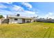 The backyard features a large lawn, covered patio, barbecue area, and block wall for seclusion at 3553 W El Camino Dr, Phoenix, AZ 85051