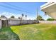 A spacious backyard features green grass, surrounded by a tall block wall for added privacy at 3553 W El Camino Dr, Phoenix, AZ 85051