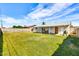 An expansive backyard with green lawn, covered patio, and barbecue area offers plenty of room to entertain at 3553 W El Camino Dr, Phoenix, AZ 85051