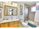 Updated bathroom with tiled shower, modern vanity, and stylish mirror at 3553 W El Camino Dr, Phoenix, AZ 85051