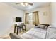 Cozy bedroom with desk and chair for work or relaxation bathed in natural light at 3553 W El Camino Dr, Phoenix, AZ 85051