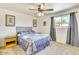 Cozy bedroom featuring a decorative ceiling fan and a comfortable bed with a stylish headboard at 3553 W El Camino Dr, Phoenix, AZ 85051
