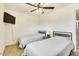 Bright bedroom with ceiling fan featuring twin beds with iron headboards at 3553 W El Camino Dr, Phoenix, AZ 85051