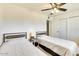Bright bedroom with ceiling fan featuring twin beds with iron headboards at 3553 W El Camino Dr, Phoenix, AZ 85051
