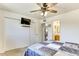 Bright bedroom featuring ample closet space and a ceiling fan at 3553 W El Camino Dr, Phoenix, AZ 85051