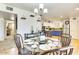 Dining area with glass table, pendant lighting, and an adjacent kitchen creates a cozy place to dine at 3553 W El Camino Dr, Phoenix, AZ 85051