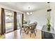 Bright dining area with wooden table set, with access to outdoor living through sliding glass door at 3553 W El Camino Dr, Phoenix, AZ 85051