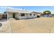 The inviting home exterior features a covered porch, a gravel yard, and an extended driveway at 3553 W El Camino Dr, Phoenix, AZ 85051