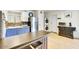 Well-appointed kitchen featuring stainless steel appliances, a breakfast bar, and washer/dryer at 3553 W El Camino Dr, Phoenix, AZ 85051