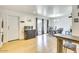 Bright living room boasts wood floors, modern light fixture, and sliding door access to outdoor space at 3553 W El Camino Dr, Phoenix, AZ 85051
