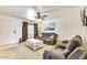 Open living room featuring comfortable sofas, a white coffee table, and ample natural light at 3553 W El Camino Dr, Phoenix, AZ 85051