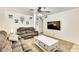 Spacious living room featuring neutral colors, plush sofas, ceiling fan, and large screen TV at 3553 W El Camino Dr, Phoenix, AZ 85051