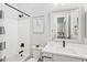 Bathroom with white cabinets, modern black fixtures, a tub, and artwork on the wall at 4024 E Minton Cir, Mesa, AZ 85215