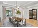 Elegant dining room featuring a long wooden table, stylish chairs, and modern light fixtures at 4024 E Minton Cir, Mesa, AZ 85215