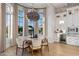 Elegant dining area with large windows, stylish lighting, and beverage center at 4024 E Minton Cir, Mesa, AZ 85215