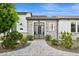 Elegant home entrance featuring a secure metal gate, brickwork and verdant shrubbery at 4024 E Minton Cir, Mesa, AZ 85215