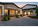 Exterior view of a home with brick accents, covered patios, and inviting outdoor seating areas at 4024 E Minton Cir, Mesa, AZ 85215