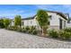 Beautiful home exterior showcasing a well-manicured lawn, stone accents and mature trees at 4024 E Minton Cir, Mesa, AZ 85215