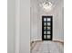 Chic foyer showcases a modern chandelier, striking front door, and wood flooring at 4024 E Minton Cir, Mesa, AZ 85215