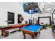 Game room featuring a pool table, shuffleboard, slot machine, and flat screen TVs at 4024 E Minton Cir, Mesa, AZ 85215