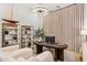 A modern home office is decorated with light walls, a sailboat decoration, and stylish furniture at 4024 E Minton Cir, Mesa, AZ 85215