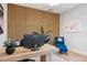 Office space featuring wood slat wall, stylish desk, a blue chair and bright decor at 4024 E Minton Cir, Mesa, AZ 85215