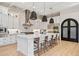 Bright, open kitchen featuring a large island, stainless steel appliances, and chic pendant lighting at 4024 E Minton Cir, Mesa, AZ 85215