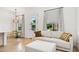 Cozy living room showcasing a white sofa, patterned curtains, and access to an outdoor patio at 4024 E Minton Cir, Mesa, AZ 85215