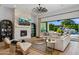 Relaxing living room with a stone fireplace, comfortable seating, and a view of the backyard pool at 4024 E Minton Cir, Mesa, AZ 85215