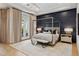 Serene main bedroom with canopy bed, accent wall, and patio access at 4024 E Minton Cir, Mesa, AZ 85215