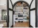 Walk-in pantry with arched double doors and filled with ample storage shelves at 4024 E Minton Cir, Mesa, AZ 85215