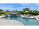 Backyard swimming pool with rock waterfall and slide surrounded by well-maintained landscaping at 4024 E Minton Cir, Mesa, AZ 85215