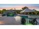 Luxury swimming pool featuring waterfall, slide, and lounge area with umbrella for ultimate outdoor relaxation at 4024 E Minton Cir, Mesa, AZ 85215